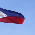 Philippine national flag against a blue sky