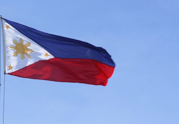 Philippine national flag against a blue sky