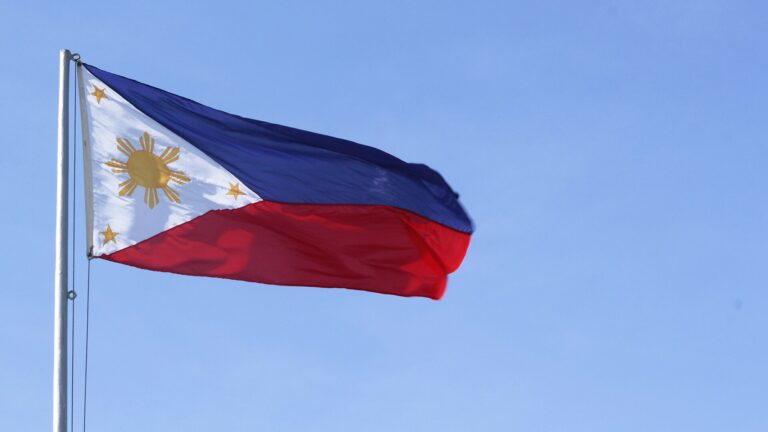 Philippine national flag against a blue sky