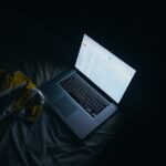 Person reading email on a laptop screen at night — welcome and nurture email sequence workspace