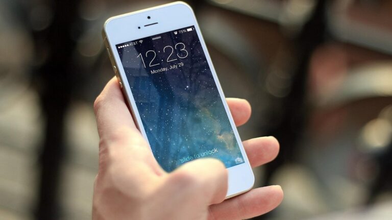 Hand holding a smartphone, ready to pay bills or buy load in a mobile wallet app