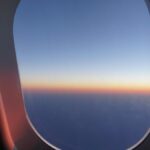 View from an airplane window at sunrise