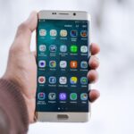 Person holding a smartphone to open a mobile bank account