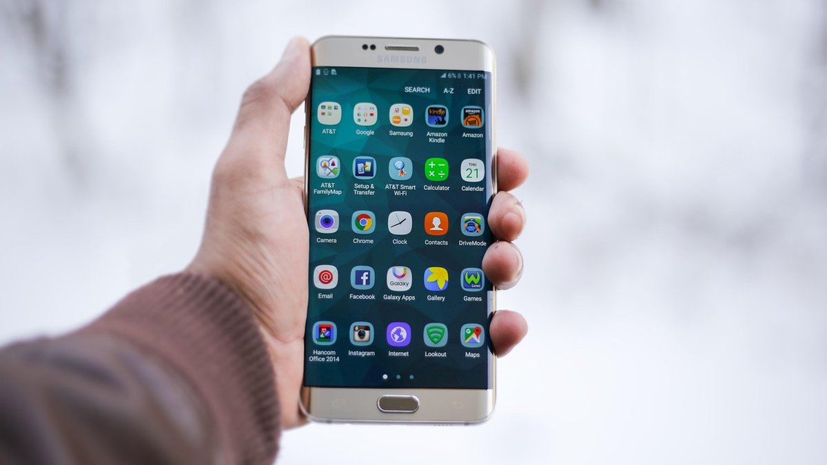 Person holding a smartphone to open a mobile bank account