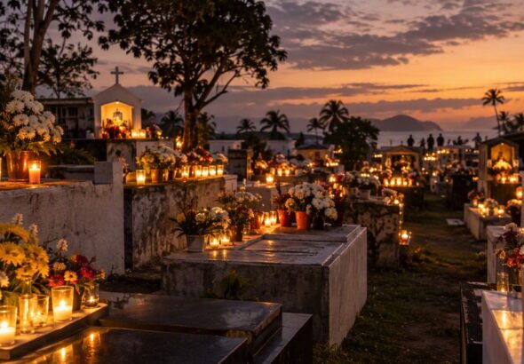 Philippine cemetery at dusk with candles and flowers on tombs during Undas 2026