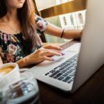 Freelancer working on a laptop at a desk with a cup of coffee
