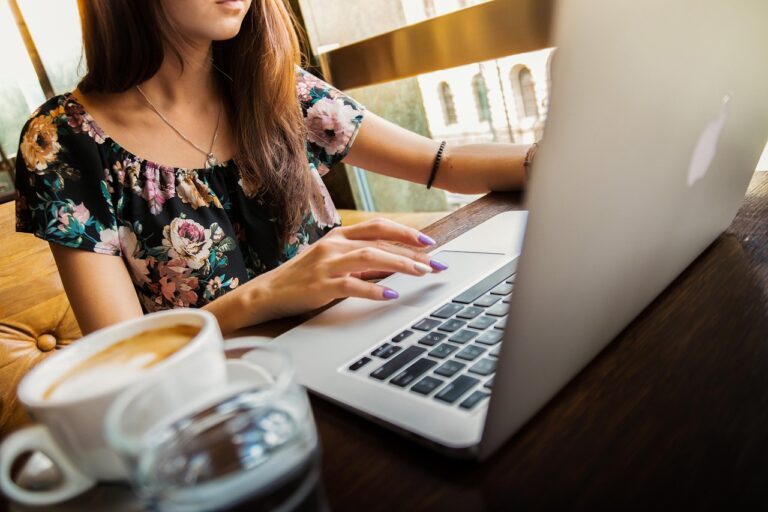 Freelancer working on a laptop at a desk with a cup of coffee