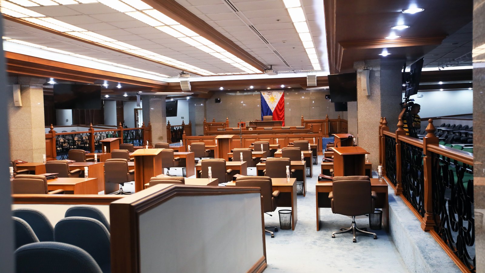 Empty Philippine Senate Session Hall with the Philippine flag behind the rostrum